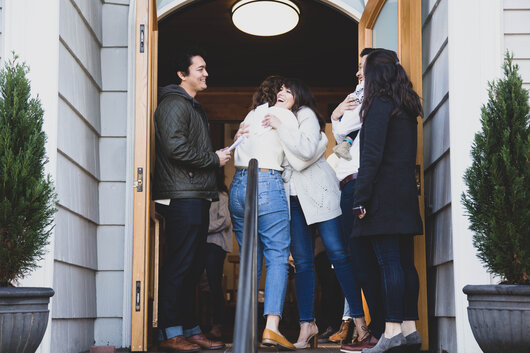 Greeter Hugging a Congregation Member at the Entrance of a Church