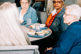 People Sitting Together at a Community Meal