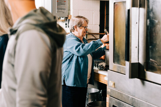 Volunteer Serving Soup for the Soup Kitchen