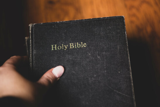 Hand Grabbing a Bible