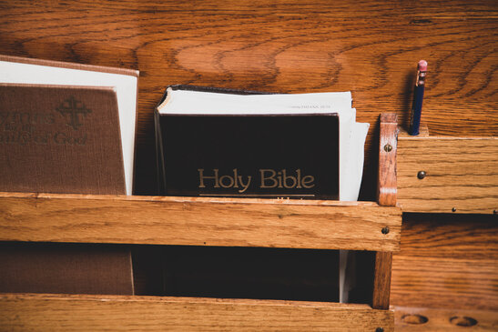 Bible in the Back Pocket of a Pew
