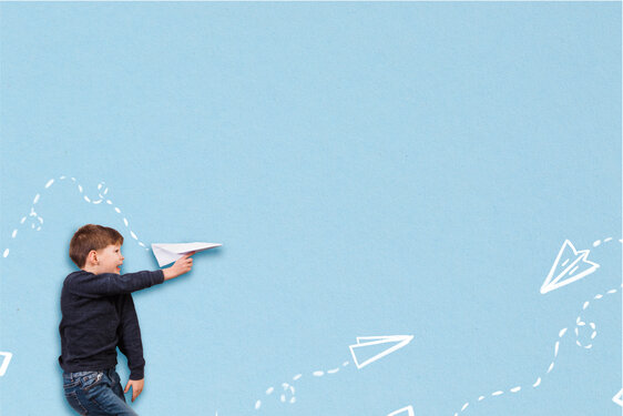 Boy Throwing Illustrated Paper Airplanes