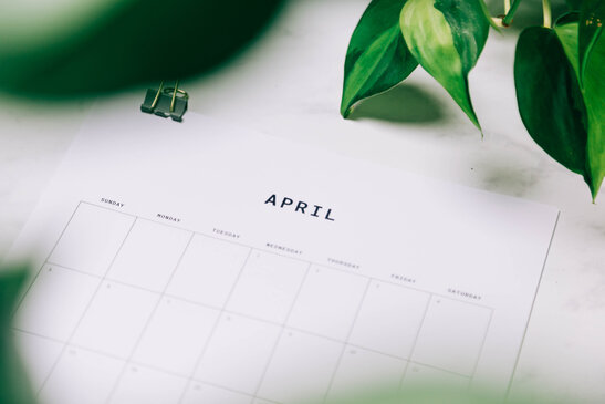 Printed April Calendar Behind Greenery