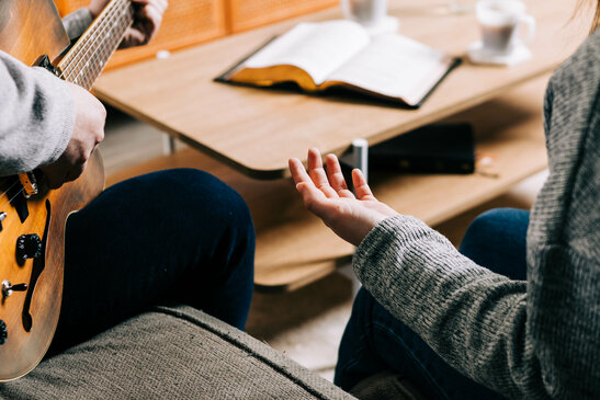 Couple Worshipping Together at Home