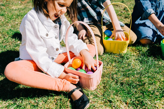 Kids Laughing and Looking Through Their Easter Eggs Together