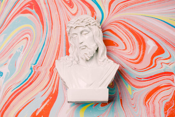 Christ Statue on Pastel Marbled Background