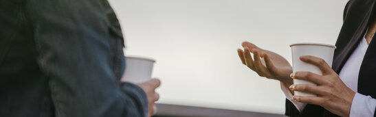 People Holding Coffee Cups and Talking