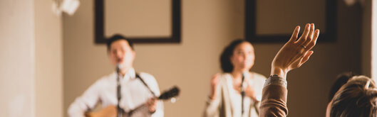 Woman Raising Her Hands During Worship