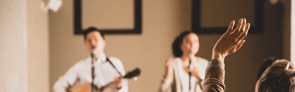 Woman Raising Her Hands During Worship