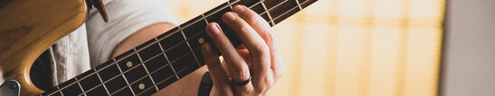 A Person Playing the Bass Guitar