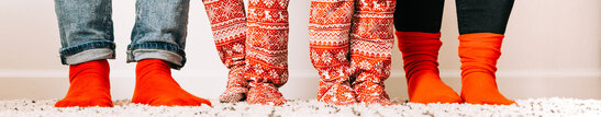 A Family Wearing Christmas Pajamas and Socks