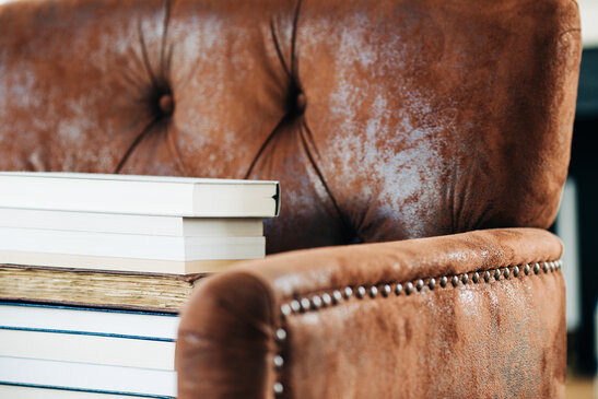 A Stack of Books on a Chair Surrounded by Books