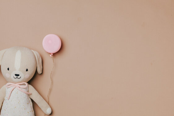 Stuffed Animal Holding a Balloon