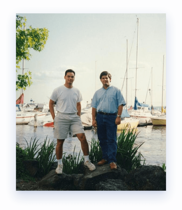 Bob Pritchett and Kiernon Reiniger standing in front of sailboats