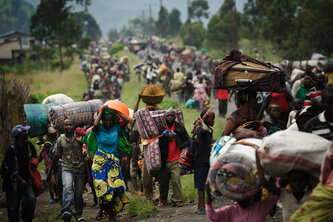 Thousands of Congolese flee the town of Sake, 26km west of Goma, following fresh fighting in the eastern Democratic Republic of the Congo town on November 22, 2012. Fighting broke out this afternoon causing people to flee the town and head east, towards Goma, to the camps for the internally displaced in the village of Mugunga. AFP PHOTO/PHIL MOORE        (Photo credit should read PHIL MOORE/AFP/Getty Images)