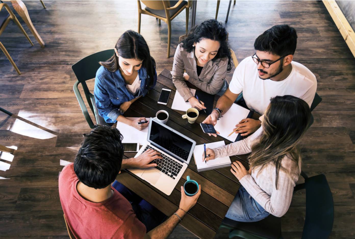 Students sitting around a table enjoying coffee and studying