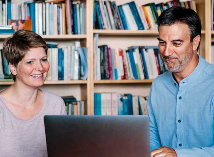 Man and Woman looking at a laptop