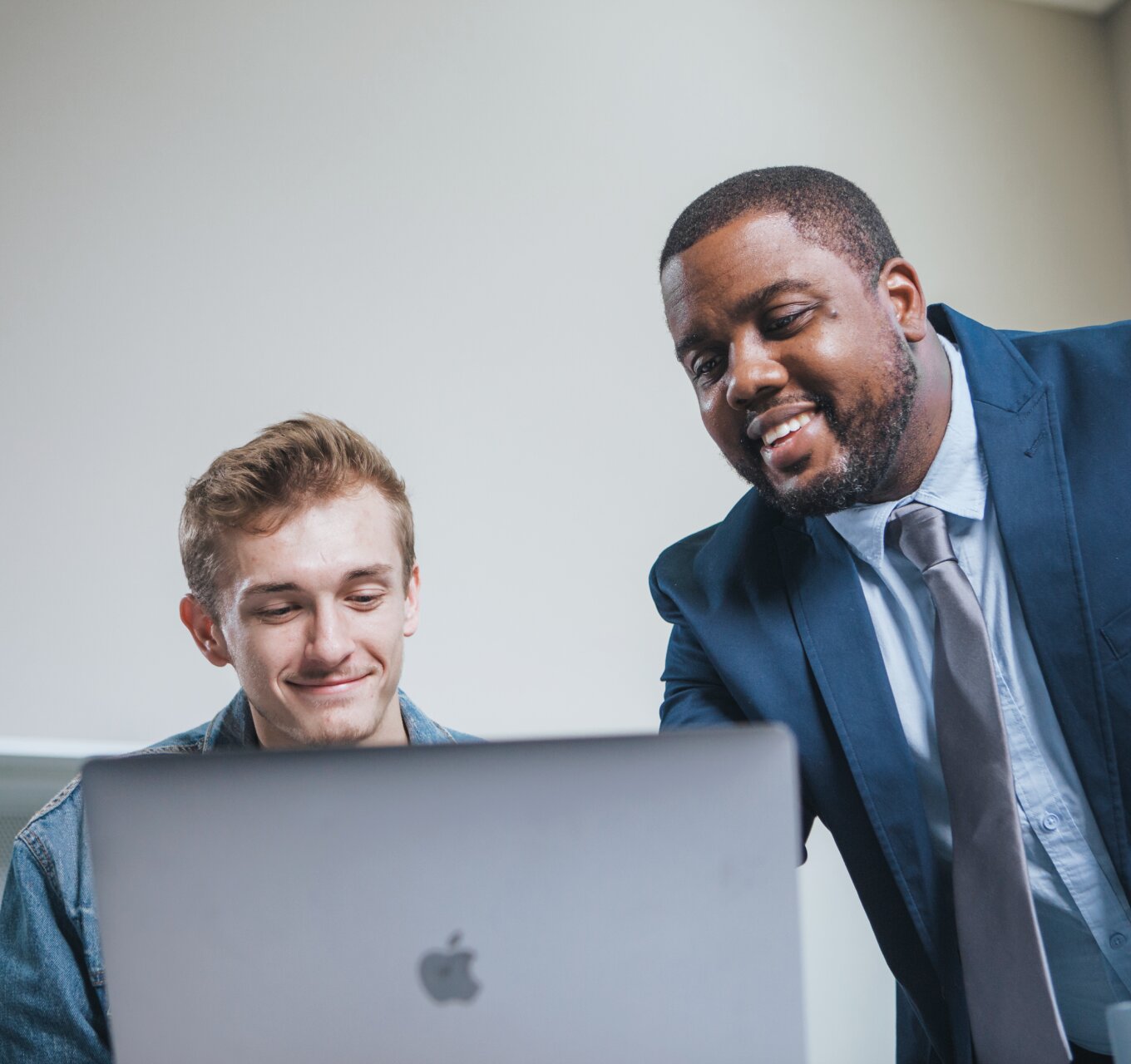 Two men in front of a computer