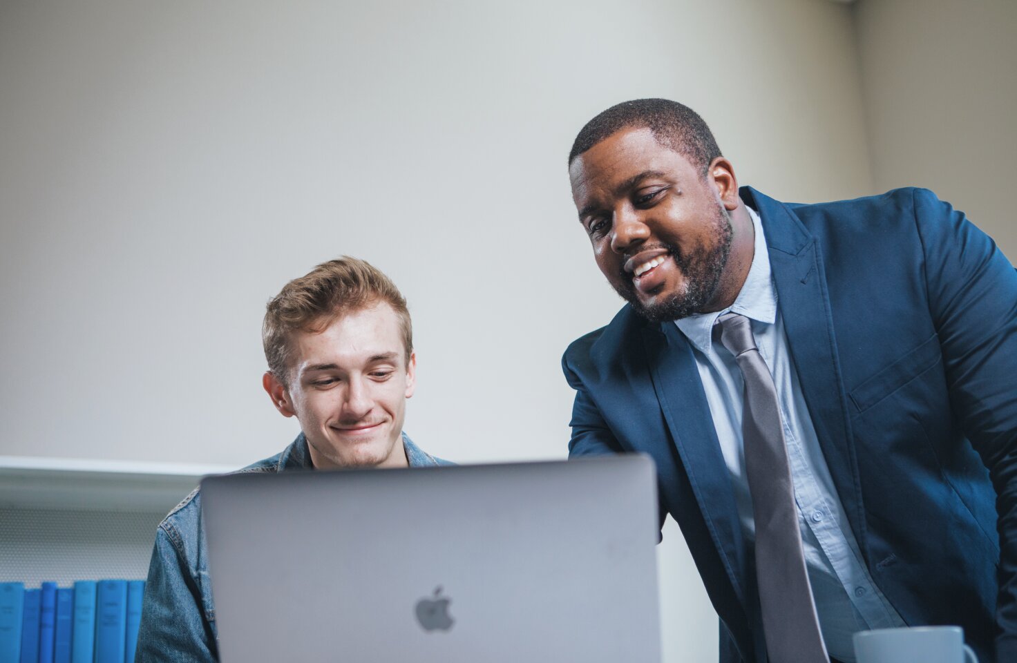 Two men in front of a computer
