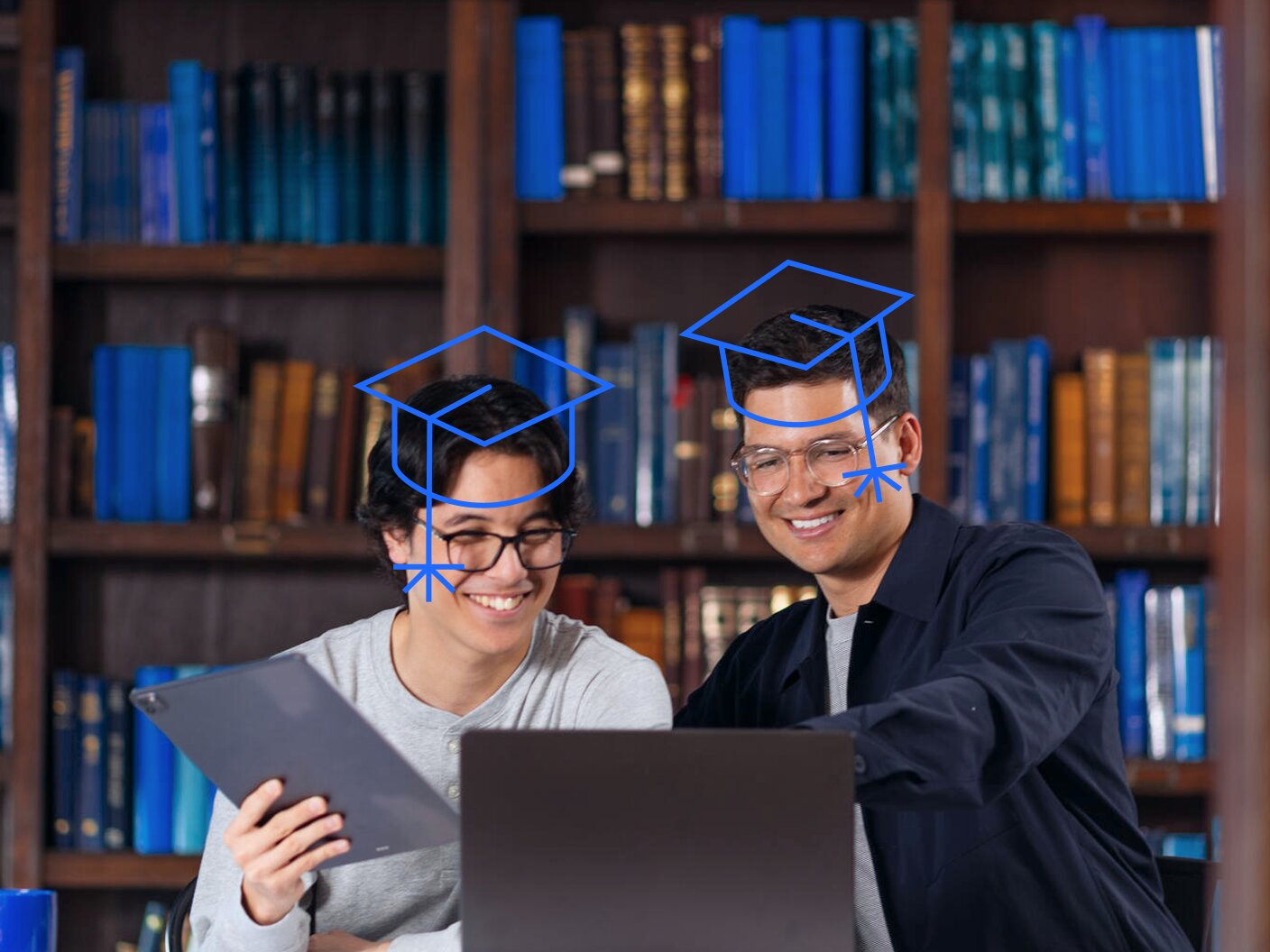 Two graduates studying together in a library