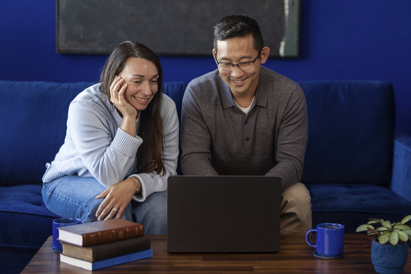 Two people studying on a laptop together