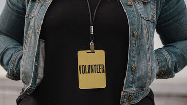 Woman in Volunteer Badge