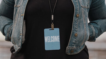 Woman in Welcome Badge