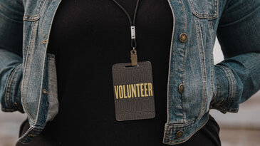 Woman in Volunteer Badge