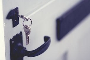 Key in white door with black handle