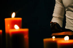 Man Reading Bible in Candle Lit Room  image 2