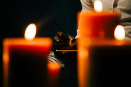 Man Writing in Notebook in Candle Lit Room  image 5