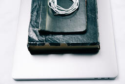 Laptop, Bible, Notebook and Headphones Stacked  image 1
