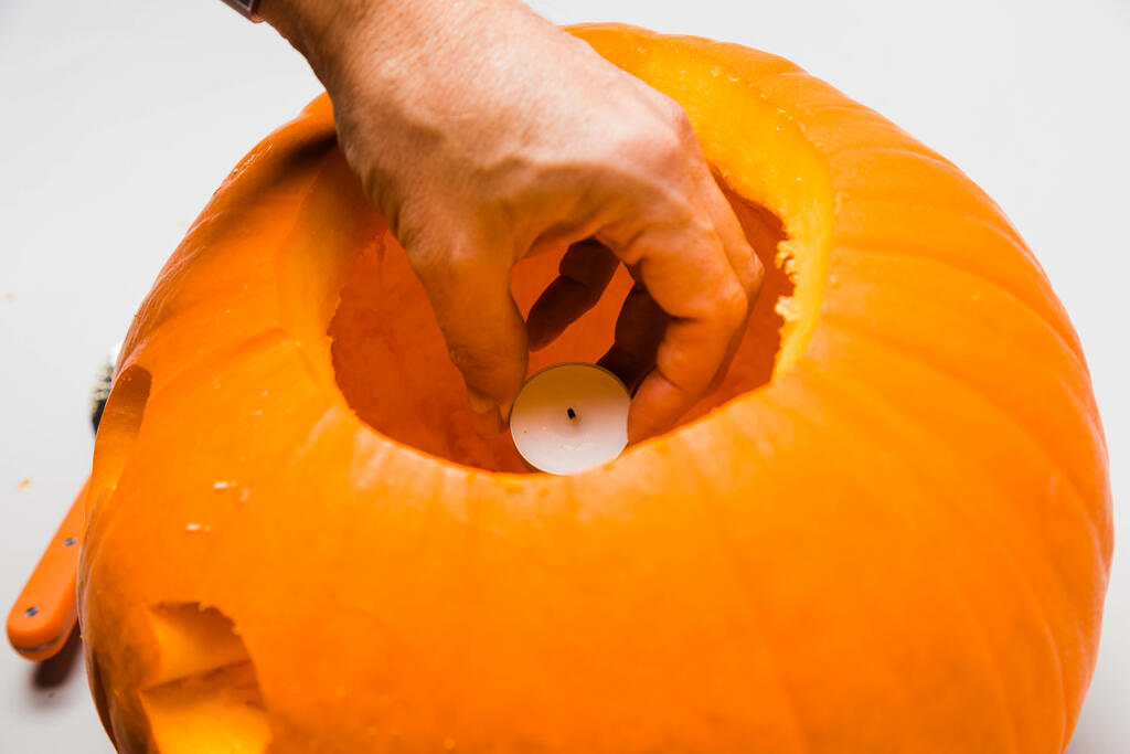 Hand Placing a Candle in a Jack-O-Lantern large preview