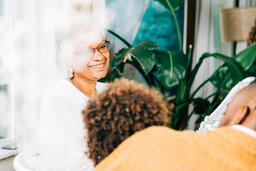 Grandmother Laughing with Grandchild at the Thanksgiving Table  image 2