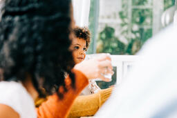 Child Seated on Father's Lap During Thanksgiving Dinner  image 1