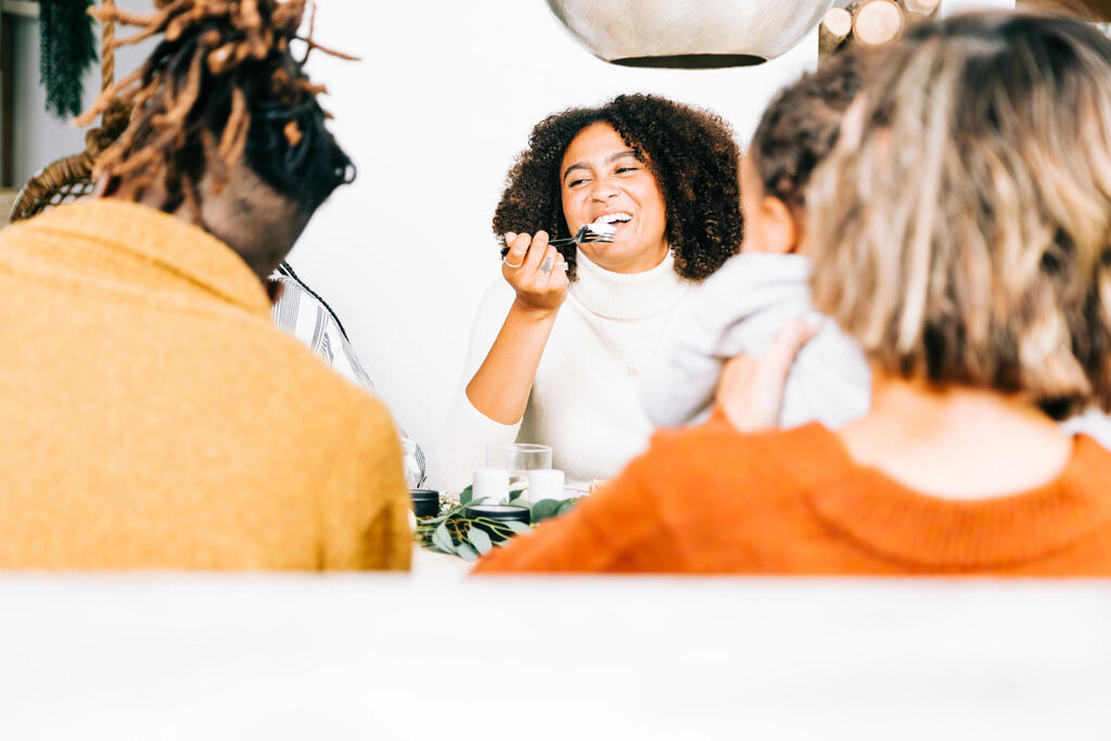 Family Laughing Together at the Thanksgiving Table large preview