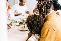 Father Holding His Son at the Thanksgiving Table  image 1