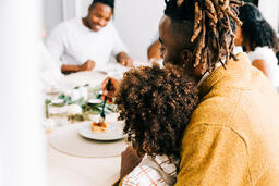 Father Holding His Son at the Thanksgiving Table  image 3