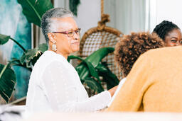 Grandmother Laughing with Grandchild at the Thanksgiving Table  image 3