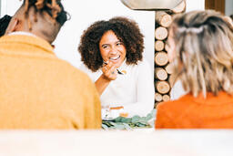 Woman Laughing with Family at the Thanksgiving Table  image 1