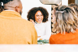Woman Laughing with Family at the Thanksgiving Table  image 2