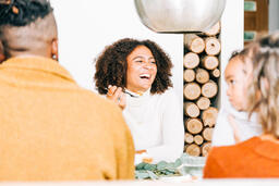 Woman Laughing with Family at the Thanksgiving Table  image 3