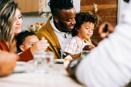 Family Seated Together at the Table Enjoying Thanksgiving Dessert  image 4