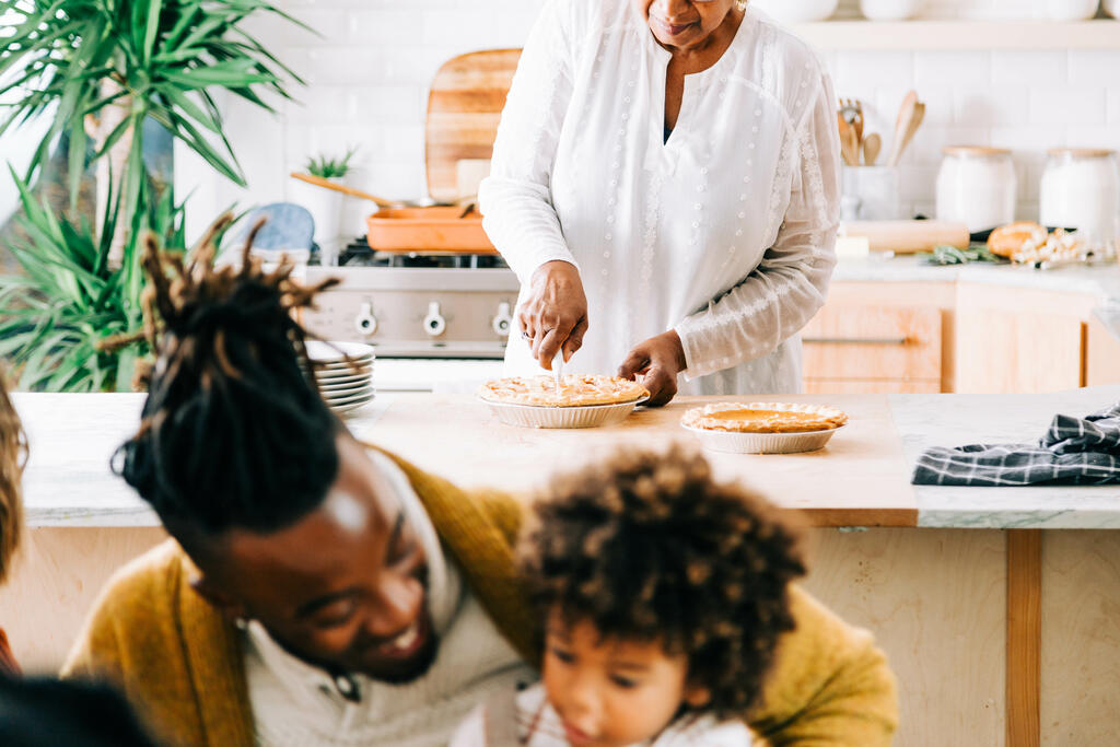 Grandmother Serving and Slicing Pie in the Kitchen large preview