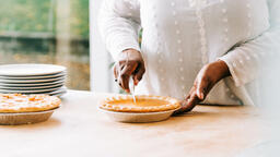 Woman Slicing Pumpkin Pie  image 1