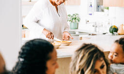 Grandmother Slicing and Serving Pie in the Kitchen  image 2