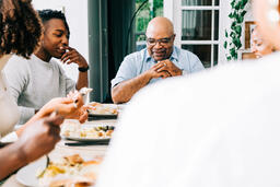 Family Laughing and Enjoying the Thanksgiving Meal Together  image 1