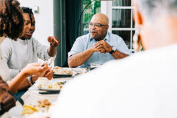 Family Laughing and Enjoying the Thanksgiving Meal Together  image 2