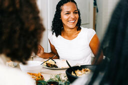 Woman Laughing and Enjoying Thanksgiving Dinner  image 2