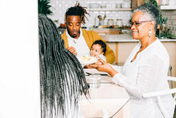 Father Holding Baby at Thanksgiving Table  image 2